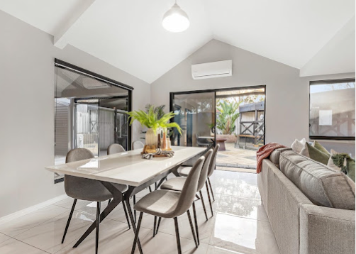Open-plan living and dining with raked ceiling after renovation