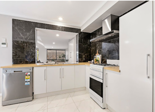 Renovated kitchen with feature stone splashback