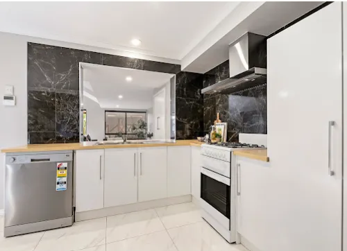 Renovated kitchen with feature stone splashback