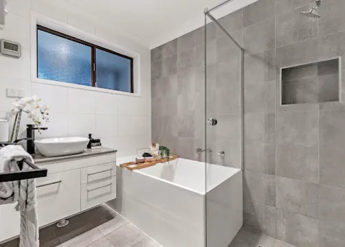 Renovated bathroom with walk-in shower and freestanding bath