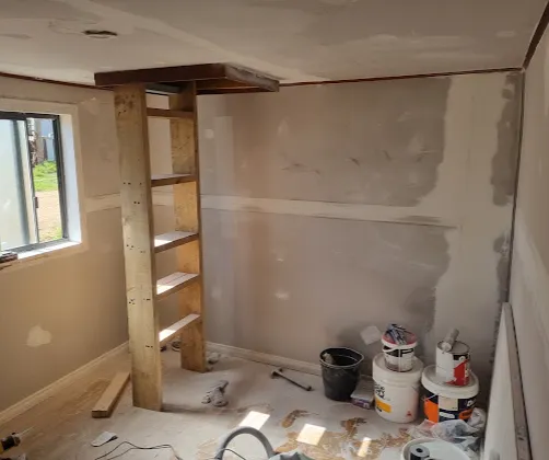 Interior mid-renovation with wall preparation underway