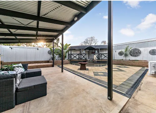 Paved outdoor courtyard under a verandah after a property makeover