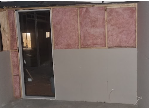 New wall being built with insulation and plasterboard